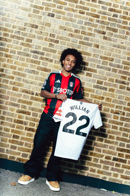 Willian holding his number 22 Fulham shirt.