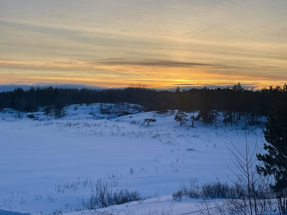 The last rays of the sun disappear over the frozen lake. It was exciting hearing the wolves call as we took this photo. #canada #sunset #canadianwinter #northernontario