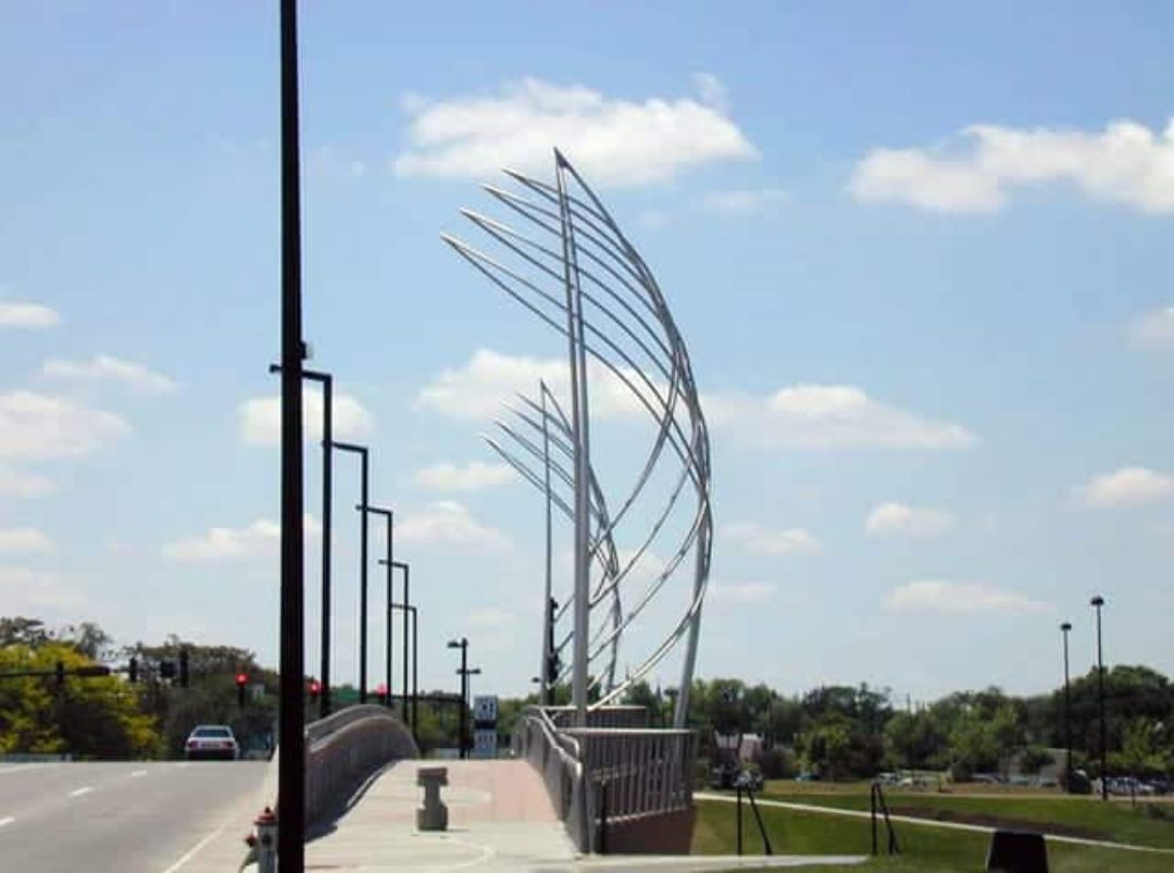 azahner's tweet image. At the Douglas and Lewis Street Bridges in Wichita, Zahner supplied stainless steel tower forms with lighting systems. The forms were inspired by Wichita’s aeronautical heritage and the Jayhawk sail boat. Read more! bit.ly/3Qbs4jz #architecture #metalarchitecture
