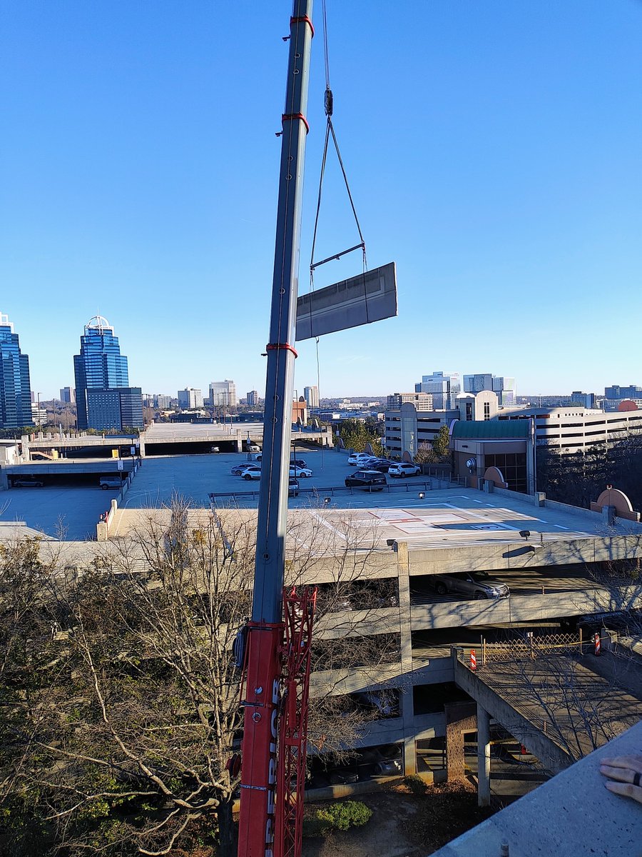 Reliant Building Solutions is reaching new heights and has been hard at work on an extensive parking garage repair at one of Atlanta’s prominent hospitals. Latest phase of the work requires us to remove pre-cast concrete panels from the top level of the deck. #Crane #Restoration