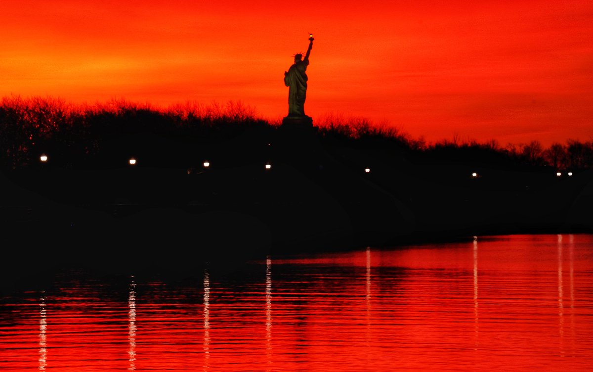 GaryHershorn's tweet photo. The sun rises behind the Statue of Liberty in New York City, Saturday morning #newyorkcity #nyc #newyork #statueofliberty @StatueEllisFdn #sunrise https://t.co/Iohq75SqSr