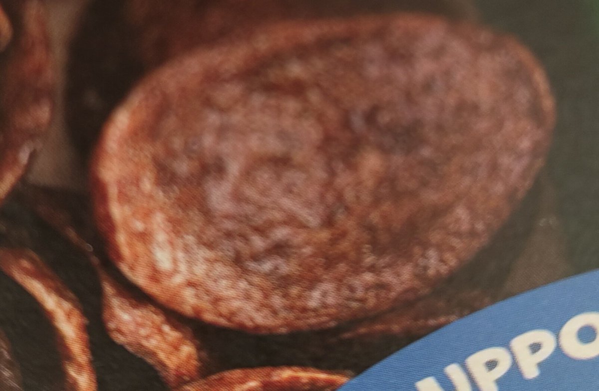 AlexDWood's tweet image. Is it me or is there a face in one of the pieces of cereal on the front of the Coco Pops Chocos box? @KelloggsUKI