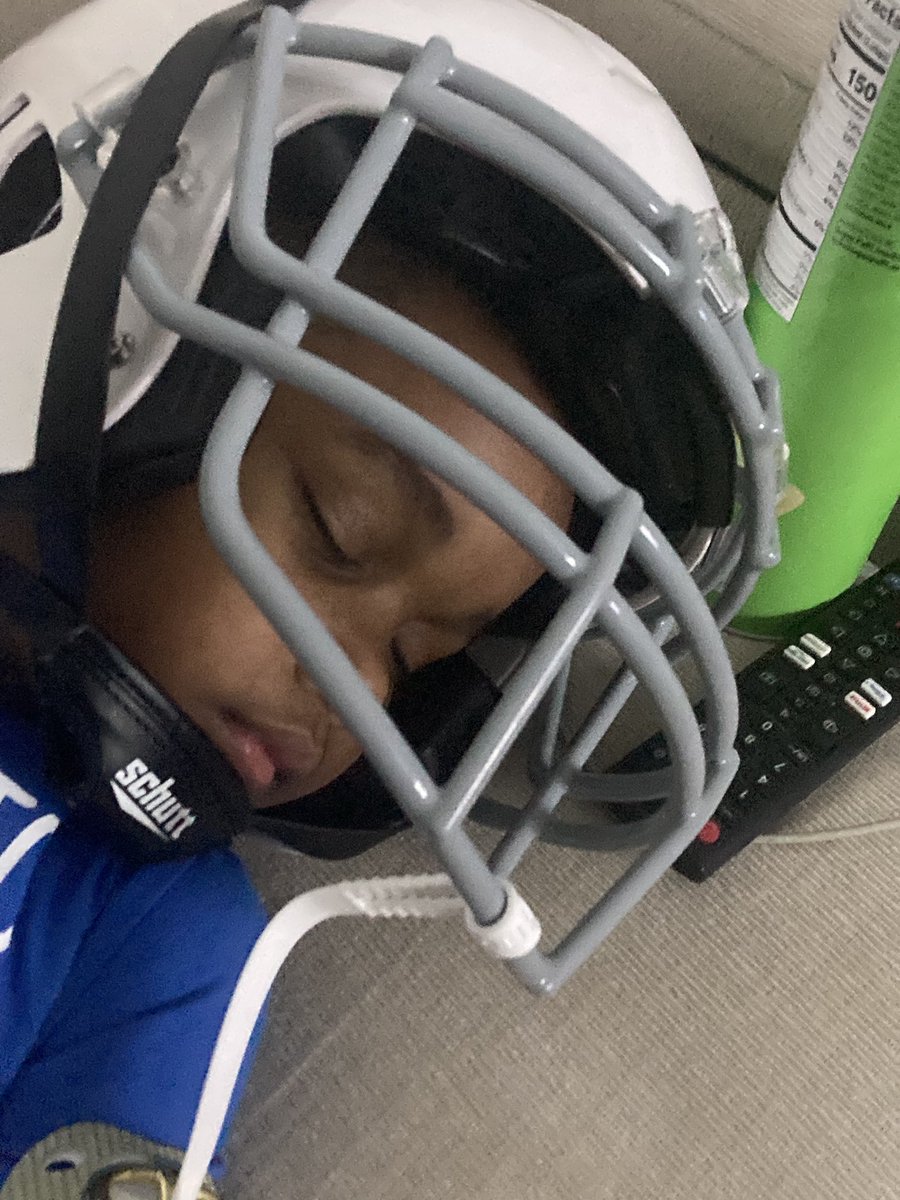 CMurdaFrmDaLand's tweet photo. Sonson fell asleep on the couch watching 7u football, wearing his new helmet I bought him yesterday 😂😂😂 It’s too cool watching your ‘mini you’ love what you grew up loving 😂🫡🖤 #TakingItOffOfHimNow 🤣 https://t.co/D5oOIjuE7q