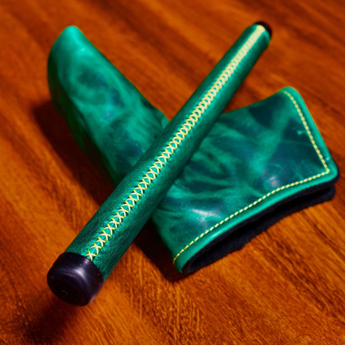 A putter grip and putter cover combo in the Horween® Dublin Leather with yellow hand-laced stitching on the grip and a yellow finish stitch on the cover.