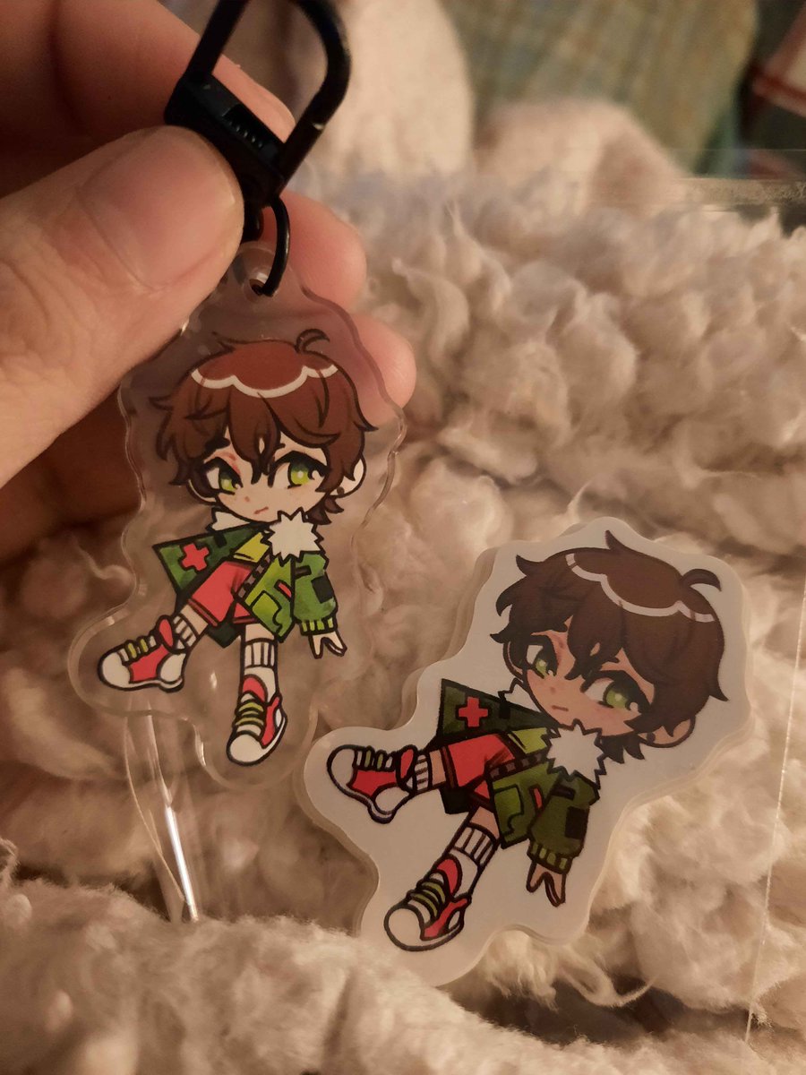 i am horrible at remembering to upload art but look at the stickers and keychains i made of my oc :]