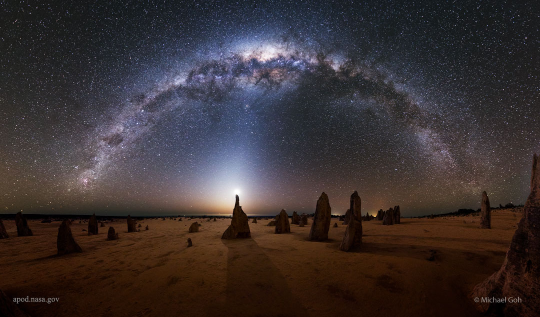 apod's tweet image. What strange world is this? Earth. In the foreground of the featured image are the Pinnacles, unusual rock spires in Nambung National Park in Western Australia. Made of ancient sea shells (limestone), how these human-sized picturesque spires formed remains unknown. In the…
