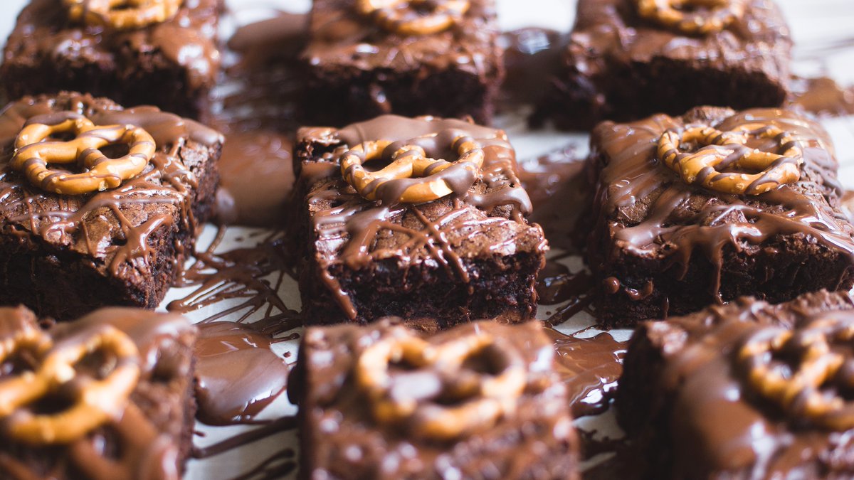 These decadent brownies are filled with chocolate and a splash of Guinness and topped with semi-sweet chocolate and pretzels. #SuperBowlLIX