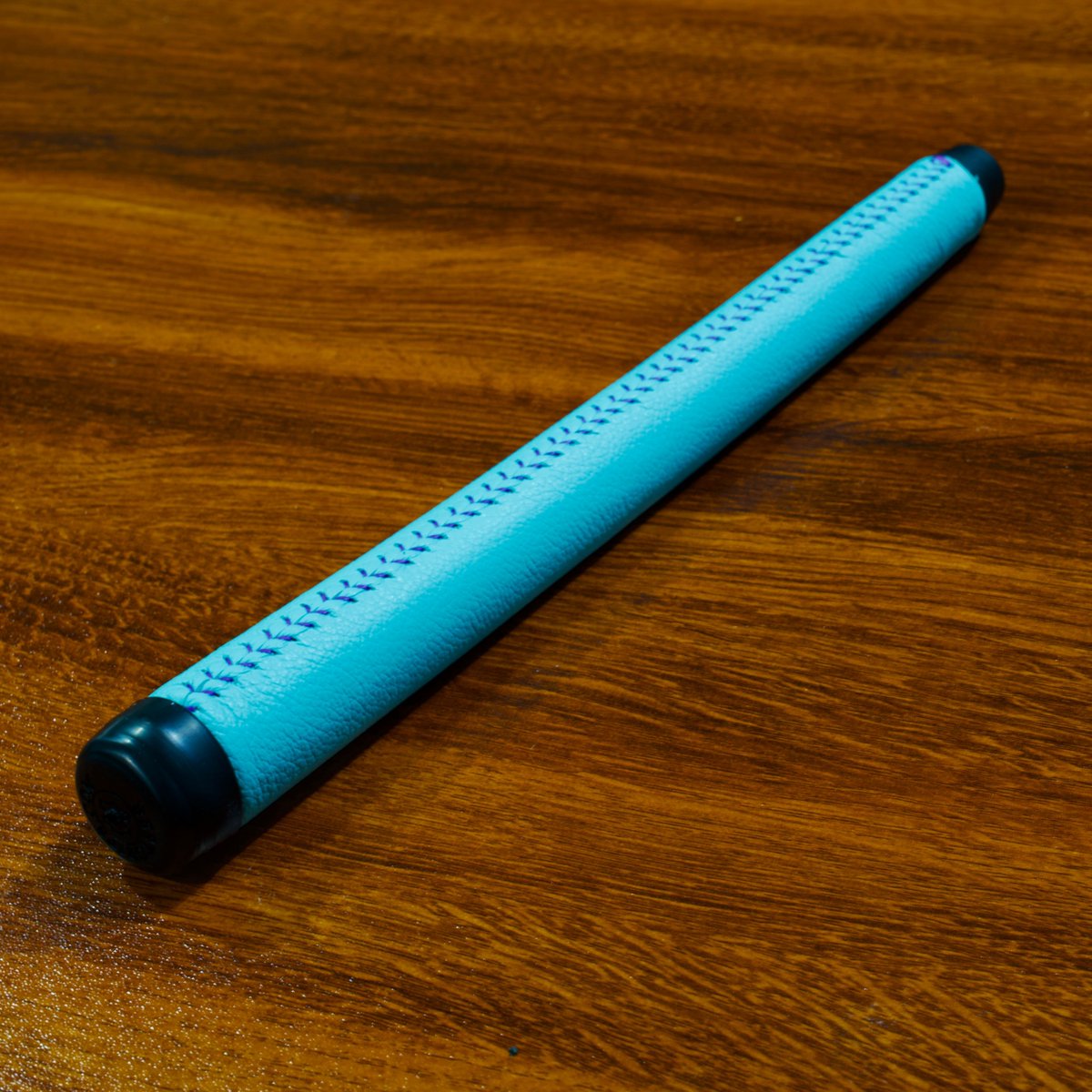 Our Robin Egg Blue Leather Putter Grip with Purple Baseball Stitch.