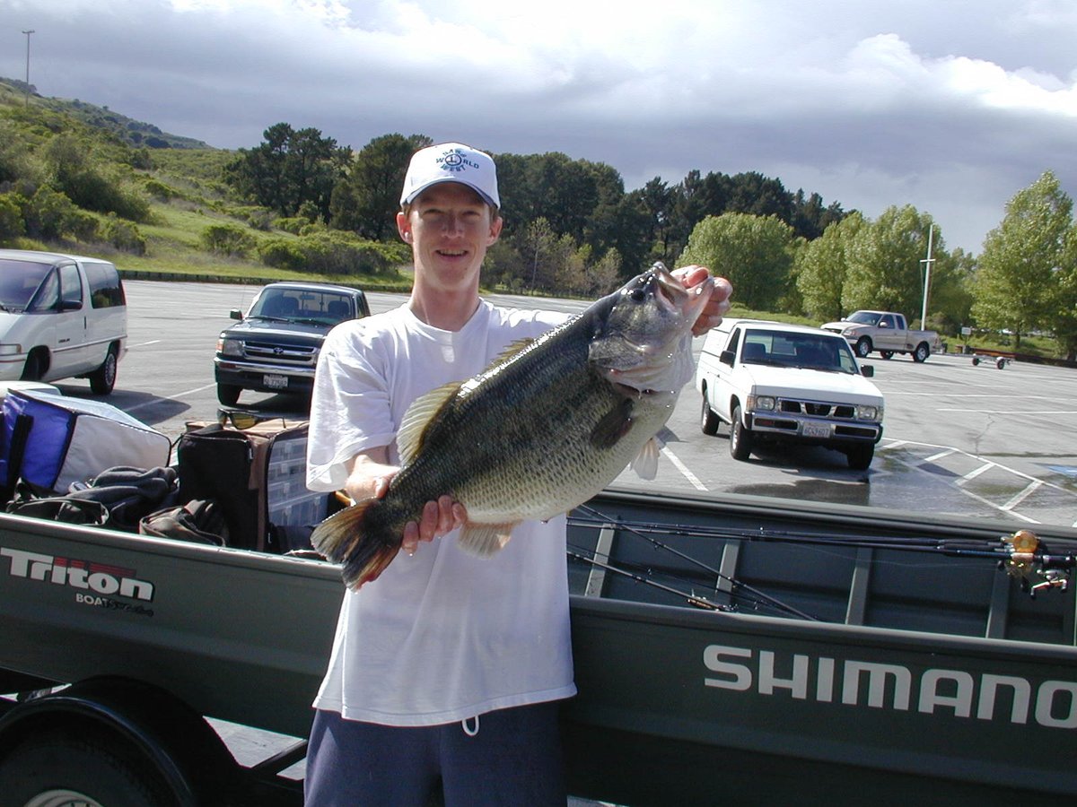 calfishingOG's tweet photo. May 3, 2003 – San Pablo Dam
Fishing for big bass is an odyssey sometimes. Today was definitely an adventure. I woke up late since the forecast called for rain. I was fishing by myself so I loaded up and left the house around 9:30am, arriving at the lake by 10:30. One thing about Pablo is that there are ALWAYS lots of boats in the parking lot, and if they aren’t bass, they are trout guys. Well, today there was one trailer in the whole lot. I could not believe it. I guess the forecast scared people away.
 
I launched the boat and it was calm and warm with a mix of bright sun and clouds. I checked some of my favorite areas and did a lot of flipping and Slammering since the water is way up and there’s lots of cover. I had two big follows on the Slammer but they were not going to bite it, they were just looking. This went on for 2 maybe 3 hours. All day today I felt like I was really in the zone. My boat was working perfectly, I was making the good casts to the good areas. But after a few hours, still nothing to show for it.
 
I decided to hit some other spots and I pulled up on a clump of tullies. A few pitches with a senko and one runs off with it. It was a zippy 4lb 2oz fish. Felt good to get a bite. Just then these raindrops start falling that are just enormous. Big fat rain, but not too heavy. I put on my rain gear and my deck boots and a few minutes later I was glad that I did because it started raining like a dang monsoon. It rained so hard for 30 minutes that there was 4” of water in the bottom of my boat! Even through my raingear, I was soaked up to my armpits. Luckily I kept a spare jacket dry in my cooler :) . Then, just as soon as it started, it stopped and all of a sudden it’s beautiful again. I really think that I was right in the eye of the storm, because it wasn’t windy all day. Even in the pouring rain, there was barely a breeze.
 
When the sun came out I fished fast with the Slammer, trying to get a fish to show itself or give me some clue as to what was going on. I saw a few 5 to 6lb fish sunning on top, but they would bolt when I got near. I did see one nice fish, maybe 12lbs, but it was just cruising. At one point, I was able to sneak up on a 5lber that I sighted from way far off. I pitched a senko at it but it just followed it down and didn’t bite.
 
Finally, I work back around to where I caught the 4 pounder. It’s still very nice out and I actually was wearing just my dry jacket while I let my t-shirt and hat dry in the sun. Then I look and see a nice fish. I’m thinking maybe 8 or 10lbs. I make a few casts towards it with a 5” Big Hammer swimbait and it doesn’t move. The beautiful thing was that even though the water was very murky, I could see this fish in the sun from about 100 feet away. So the fish never knew I was there. I made a few more casts, maybe 4 or 5 casts and the fish was staying there, but not interesting in my bait.
 
Then, as I’m watching, I see another fish move up by this fish. Keep in mind that I had absolutely the most perfect positioning on these fish. I was almost 100 feet away from them. It was so far I could barely make the pitch underhanded, and one thing I know how to do it pitch :) The other fish looked bigger but was very green and hard to see. At this point I realized the first one I was looking at was probably more like 10 or 11lbs. I lined up a cast on the other fish and it didn’t move. The next cast I swam my swimbait in from about 10 feet past the fish and shook it on it’s face. THUMP THUMP. Whoa! I couldn’t believe the fish ate it that quick!! I nailed her good and she ran out towards deeper water. She didn’t come up until she was about 30 feet from the boat and when she rolled I started getting excited because it was definitely a TOAD. I was thinking she was about 12lbs, and then she went and dove under the stern of the boat. I ran back there and coaxed her back out to the side. Grabbed the net and held it between my legs and I led her towards it. She came up really docile by the side and I slid her in, then I dumped the rod, grabbed the net with both hands and lifted her in.
 
So here is where karma comes in to play. About 2 weeks ago I bought a new cooler for my boat. It’s 152 quarts, which is overkill, but dammit, I figured the only fish I am brining in that cooler is going to be a really really big bass, that needs a really really big cooler! That was some good karma. The other karma was that I had about 2” of standing water on my lower deck from the rain. So I just laid her there for a minute (in the deep end of course :) ) while I filled the cooler, then I laid her in the cooler and sprinkled a little catch and release formula on her.
 
I took a minute to try to calm down because I knew she was big. I was thinking now that she was probably 14 to 15lbs. I got the scale and lifted her up. The scale flashed and settled on 17lbs 14oz. I was like WHAT?!!???!!???!?!???!?!! I just stared at it for like 5 seconds waiting for it to go down, but it didn’t. I put her back, held down the power button and zeroed the scale again. I put her back on it one more time and it hung right to 17lbs 14oz again!!! I could NOT believe it. At this point I was starting to lose my mind.
 
I was very close to the ramp and I kind of debated doing the self taken pics and releasing her or taking her in for an official weight. I called B and J and idled closer to the ramp. Then I said, to hell with it, I have a 152 quart cooler, I’m taking her in. I got to the dock, jumped out and ran up and got the truck because there was no way in hell I could carry that cooler full of water up to the marina shop. I pulled out and parked right at the back door. The guy was working by himself and there was literally no one for 100 yards. We drained off enough water to get the cooler over the gunnel and carried it about 50 feet up to the scale. He got the scale ready and I lifted her out and put it on the scale. The scale flashed for a split second and then just pegged at 18.0lbs!!! The guy at the shop was pretty excited and I was just about to pass out. What a fish! She was not super long, but she had this gut on her that was unlike any fish I have ever seen in person.
 
We carried her back to the boat and he helped me get the cooler back in the boat, then I drove down by myself to the ramp. I could have launched and taken her back to her spot, but I didn’t feel like that was in the best interest of the fish. She was doing great and I wanted to keep it that way. I dumped most of the water so I could get the cooler out of the boat, just about killing myself in the process, then I snapped one pic in the cooler, took her out and released her. She was awesome, she just pointed out and swam off steady and strong. I snapped two quick pics as she headed out. One day this bass will be 20lbs. I know it in my heart. Letting her go was one of the awesome moments in my life. The stars really lined up for me today.
 
I did forget to measure the fish, which I am really upset about. Based on the pics in the cooler and working with N, we are estimating that the fish was between 26 to 27” long and had a girth of around 27”. For your reference, the cooler is 14” across the bottom, and 37” long. Each little panel along the side is 4 and ¼”long, not counting the groove between the panels. I know myself when I look at the pic of me holding the fish, it doesn’t look like an 18lb bass, but if you could just see the massive girth on her, like you can kind of get a feel for in the cooler pic, she was really something.
 
Here is the gear
 
5" #36 Prizm Shad Big Hammer Swimbait - I opted for a natural bait because I was not sight fishing in the sense that I could see my lure
 
Castaway FR76 Flippin Stick
Shimano Curado 200b
20lb Triple Fish Camoescent line
luck - lots of it
 
Catch and Release Forever

What worked: 5” Big Hammer Swimbait

https://t.co/8M1SYYpCfH

Where did you fish? San Pablo Dam

https://t.co/gZ8qLmVFyX