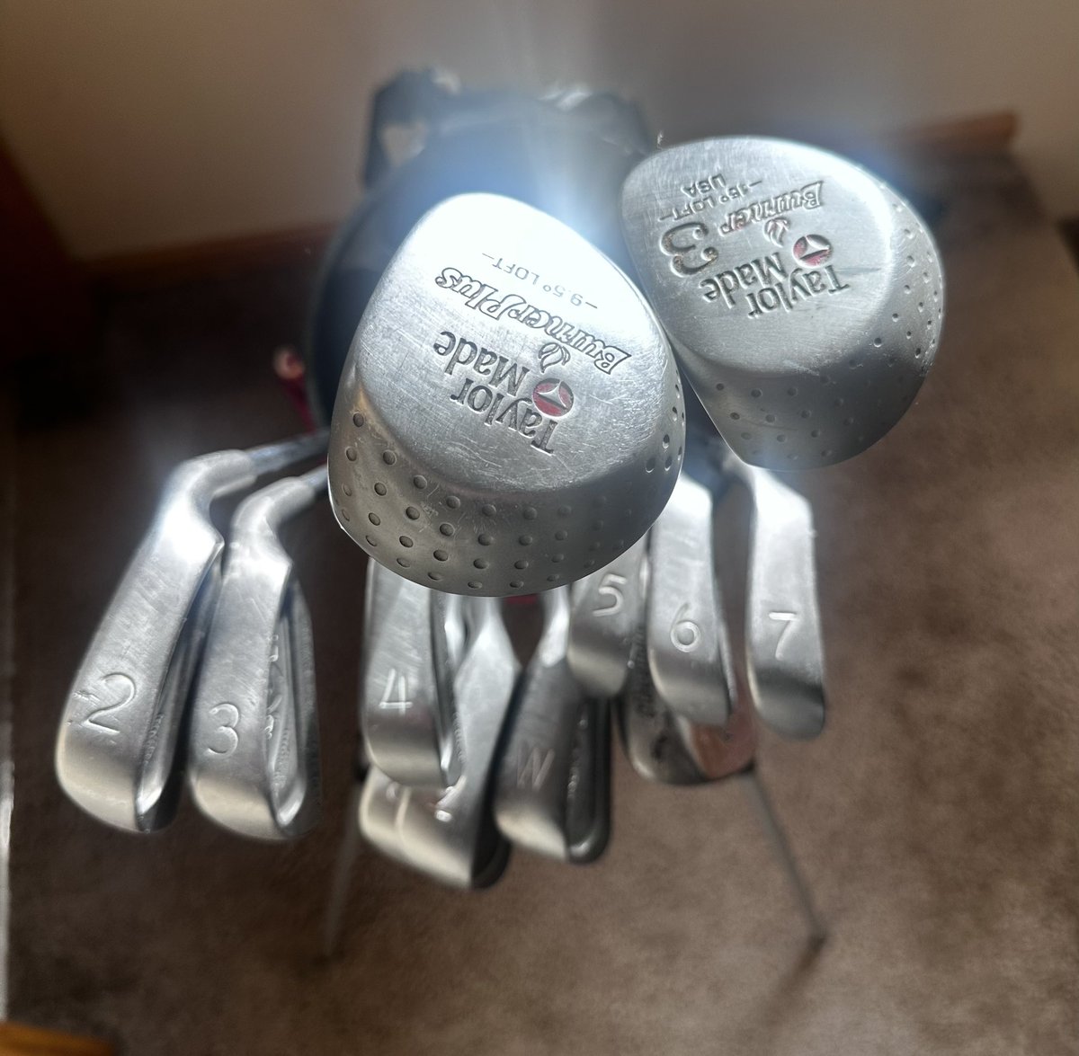 MAtchisonGolf's tweet photo. @MyGolfSpy Still have my set from High School circa 1994: Burner Plus w/FlexTwist Titanium, Burner 3 FW w/ DGS300, 2-SW Ping Eye 2 Red dot, Cleveland 588 SW, Ping Anser putter in Ping Stand bad w/Izzo Strap…must admit looking down at these irons now, they look hideous way too much offset🤣 https://t.co/vroaAiQnKo