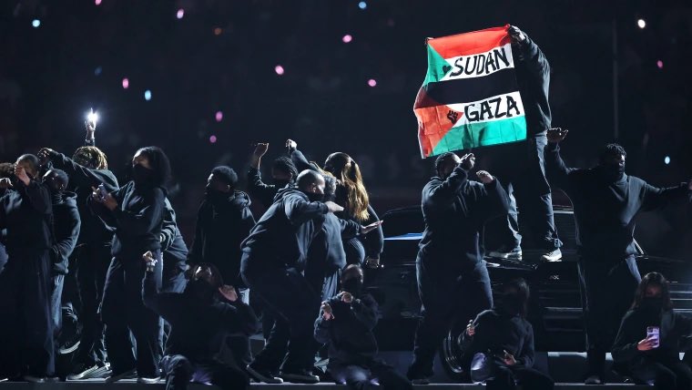 PopCrave's tweet photo. The cast member who displayed the Palestine and Sudan flags during Kendrick Lamar's #SuperBowl Halftime show will not face charges. https://t.co/RfqpfQPLGt