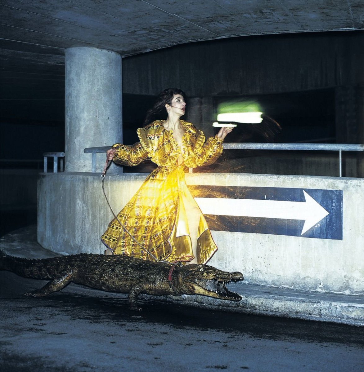 Kate Bush with crocodile in a parking garage, 1979.