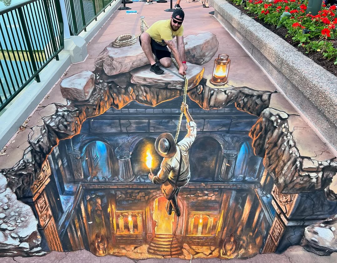 DrewDisneyDude's tweet photo. Nate Baranowski’s latest 3D chalk art featuring Indiana Jones at the EPCOT International Festival of the Arts is a masterpiece. 👏 https://t.co/ya83pbCQnB