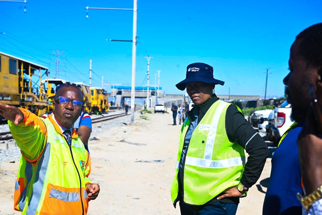 PRASA_Group's tweet photo. The CEO of PRASA Rail, Mr. Nelson Malefane, along with the Western Cape Rail management and technical teams, are currently conducting a site visit to the Central Line, including Nolungile, Nonkqubela, and Kapteinsklip stations. This visit aims to assess the progress made thus far as the region prepares for the upcoming extension of services on the #CentralLineCT. #RebuildingRail