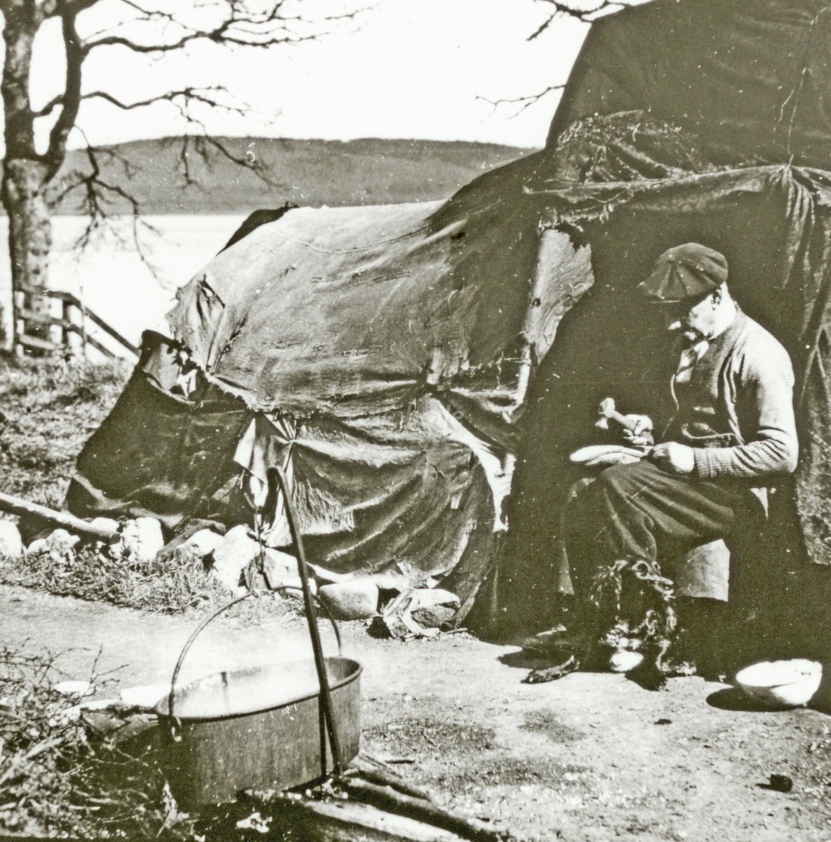 A member of a Highland travelling family reapairing a boot or shoe, his dog at his feet, c1930s

[source: Gordon Shennan Collection; <a href="/InvMAG/">IMAG</a>]