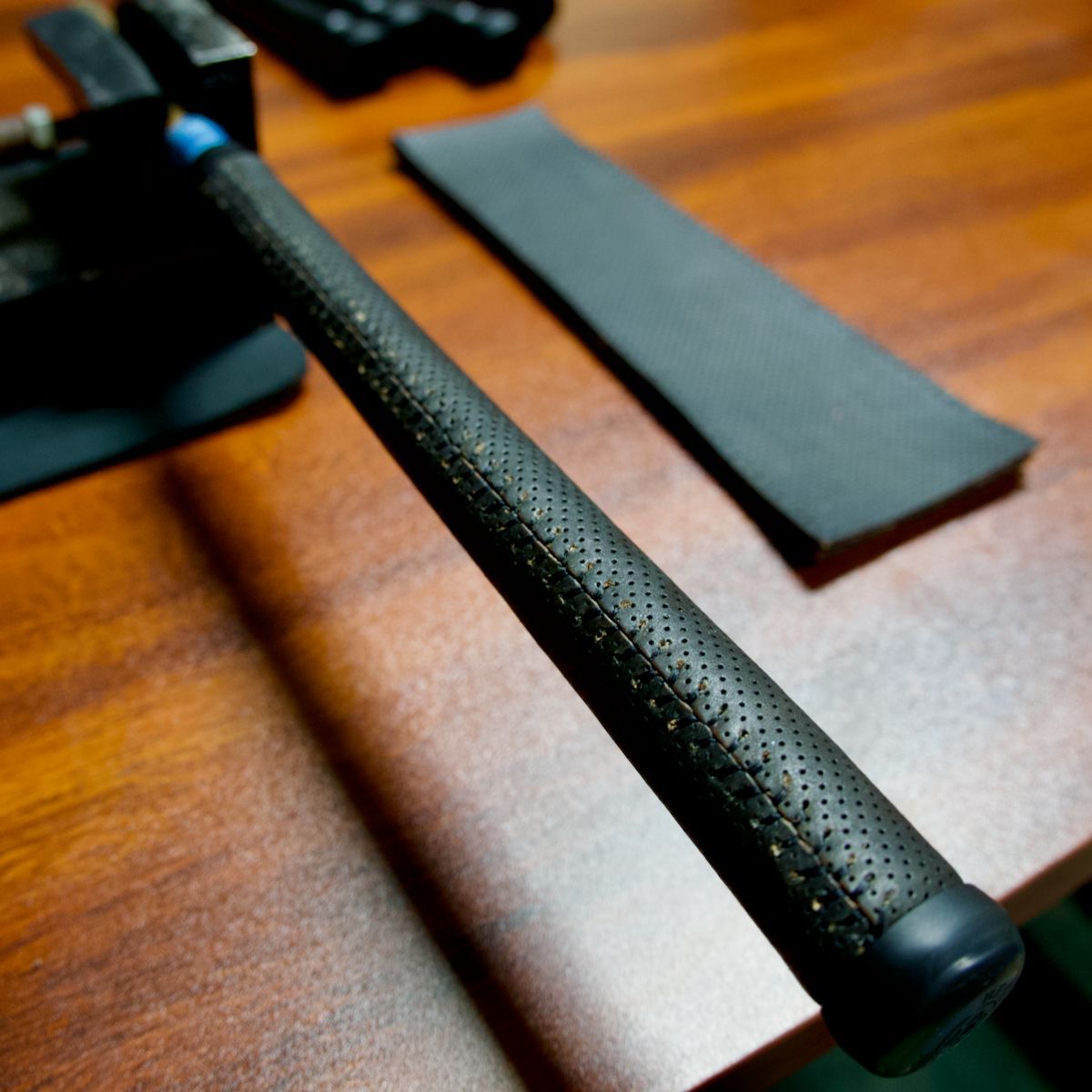 A fresh MicroPerf Leather Golf Grip off the line in one of our stock combos: black on black.