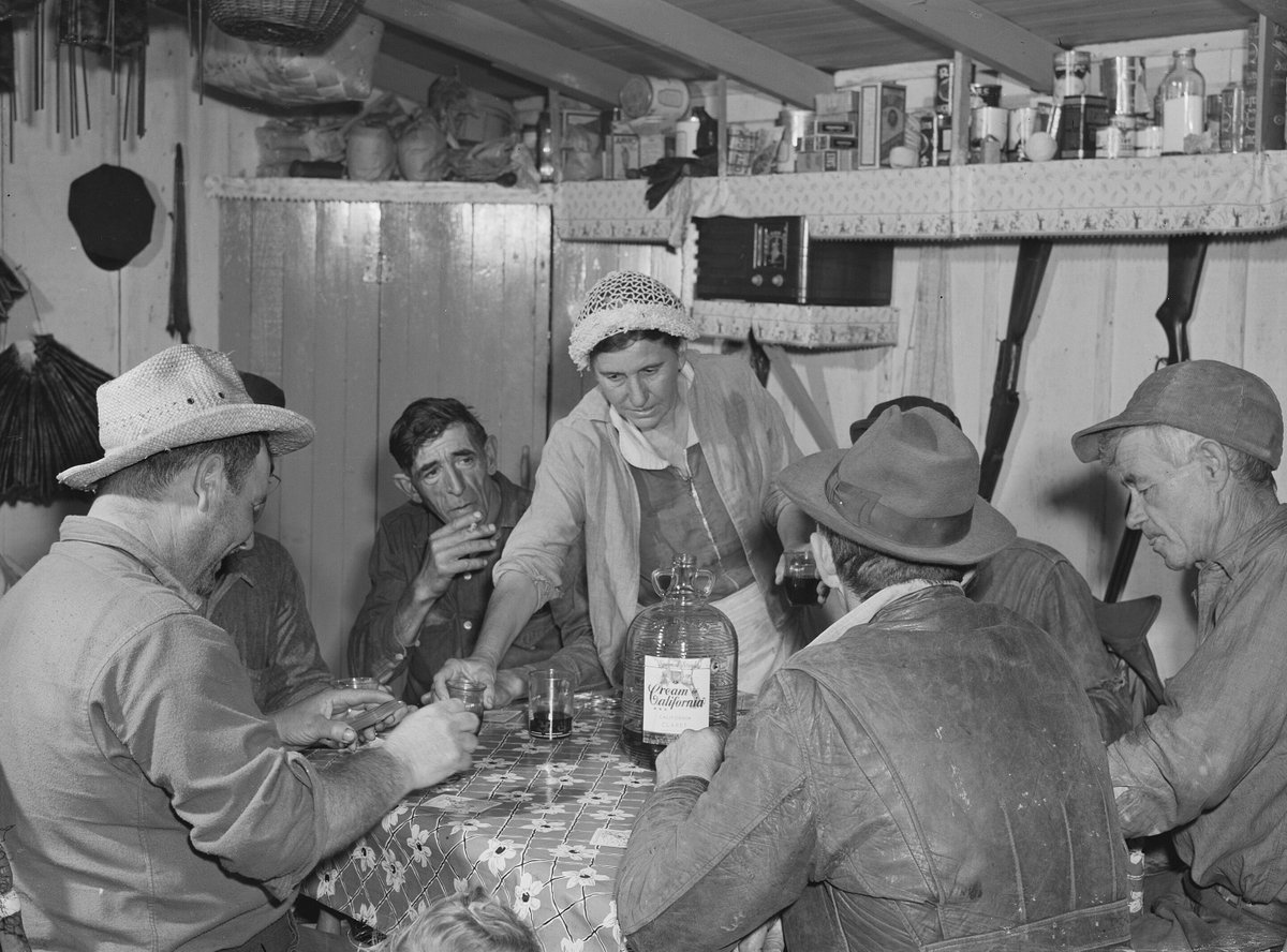 Where it began: Muskrat trappers in Delacroix, Louisiana, in 1941, gathered around a large bottle of "Cream of California, California Claret," an early Gallo mass-produced wine.