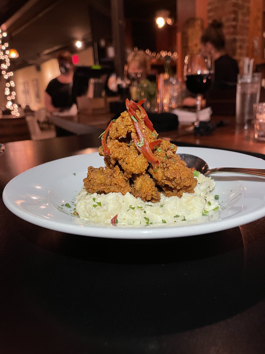 Aww, shucks! It's Chef Jereme's Spicy Oyster appetizer, featuring wild-caught Chesapeake Bay oysters fried in a spicy house breading, and served atop creamy Weisenberger parmesan grits, with pickled Fresno peppers and parsley. #bourbonsbistro #menufeature #dinnermenu