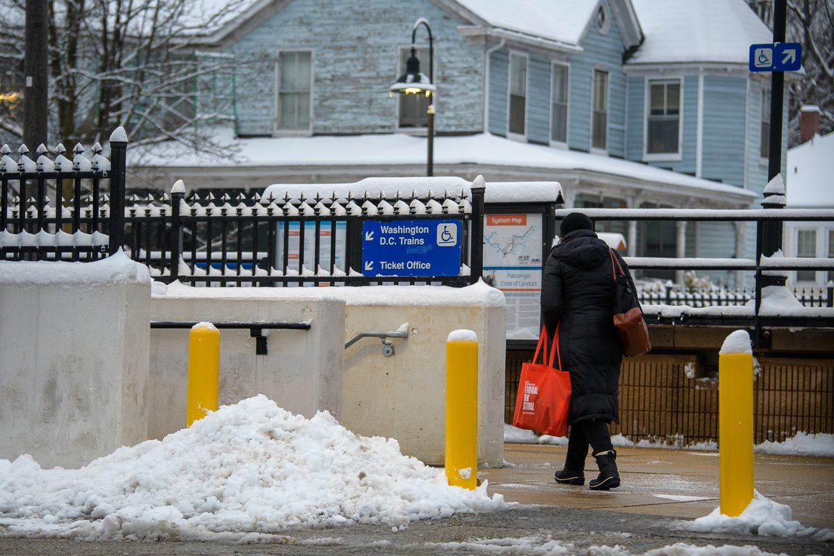 A person walking to a train platform