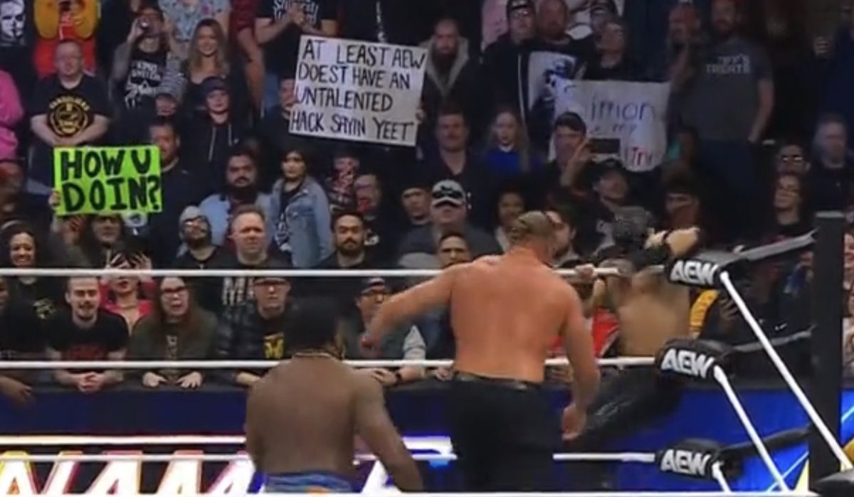 nodqdotcom's tweet photo. "At least AEW doesn't have an untalented hack saying YEET" sign in the crowd at #AEWDynamite. https://t.co/NZ2MCNniM9