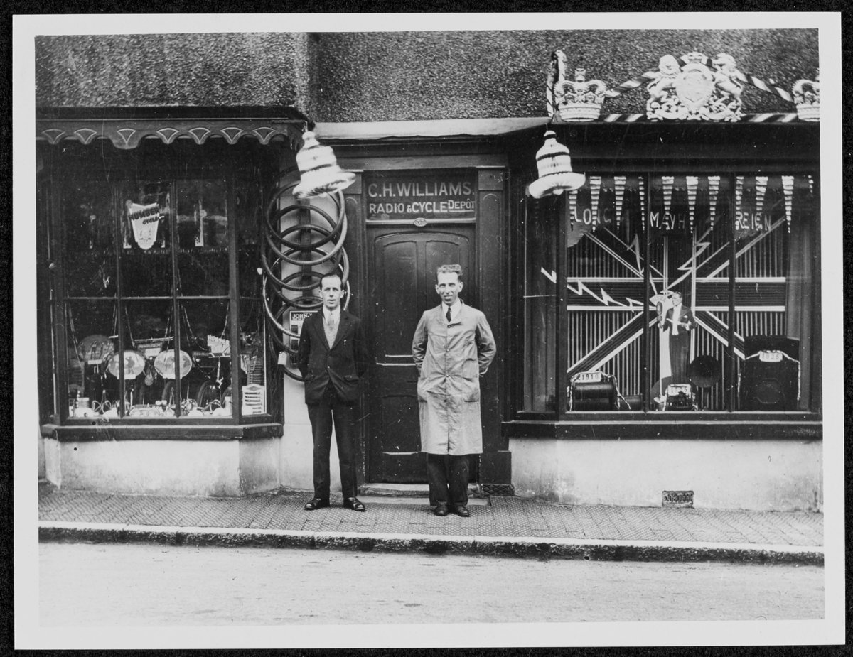 Here we can see two gentlemen smiling outside a Radio and Cycle shop (Ruthin, 1935). This photo inspired us to take part in #Radioday, are there any photographs in our collections that have inspired you? (PPD/90/299)