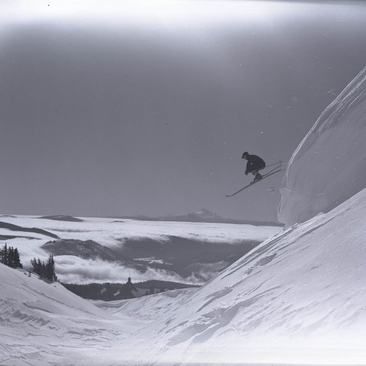 Due to inclement weather, the Secretary of State is closed on Thursday, February 13th. 
(Image: Olof Rodegard jumping a snow cornice with Mt. Jefferson in the background, Oregon State Archives collection)