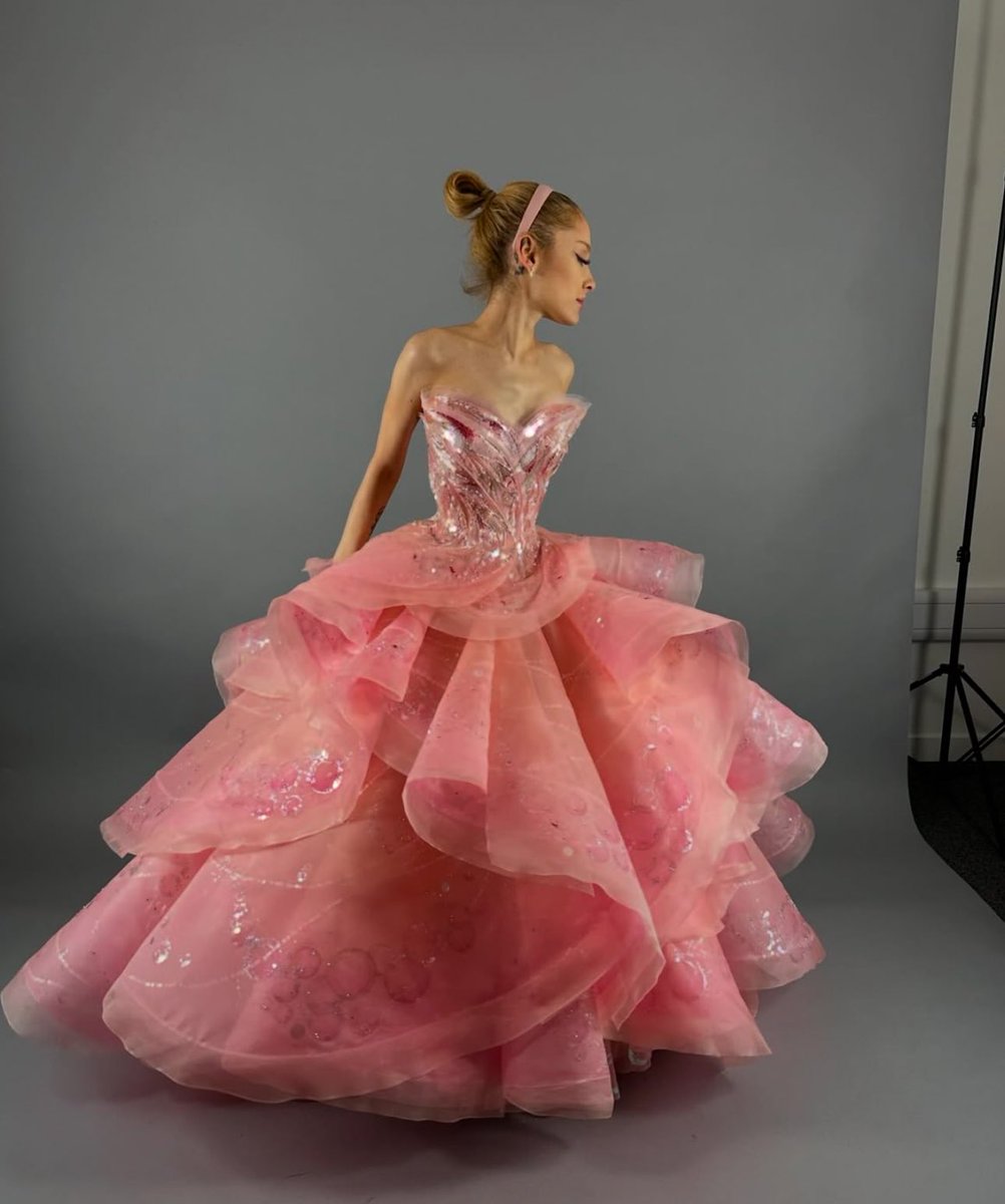 Ariana Grande shares photos from her Glinda pink dress fitting.