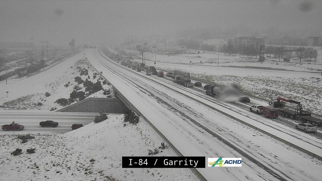 NWSBoise's tweet photo. Snowfall in the last hour has rapidly increased. Here is a traffic cam along I-84 &amp; Garrity Blvd. In the last 2 frames, you can see the visibility rapidly decrease and traffic stopped in the still image. https://t.co/OM9KTbh0sQ