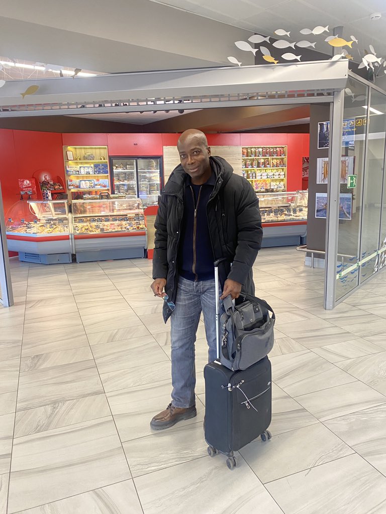 At airport between restaurants and duty free shop waiting to board