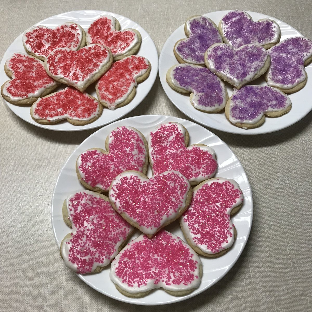Fresh baked heart shaped sugar cookies with maraschino cherry flavoured icing and sprinkles! tyrabakes.com #HappyValentineDay #bakery