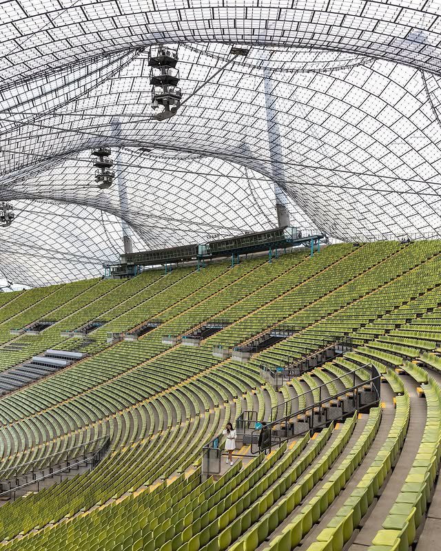 parametricarch's tweet photo. 🧵1/3
The Munich Olympic Stadium, designed by Behnisch and Partners with Frei Otto, was built for the 1972 Summer Olympics to represent West Germany’s democratic renewal. Unlike the rigid, monumental architecture of the 1936 Berlin Olympics, this design embraced transparency and openness, symbolizing a break from the past. Inspired by the rolling Bavarian landscape, the stadium was partially sunken into the ground, creating a less imposing presence.