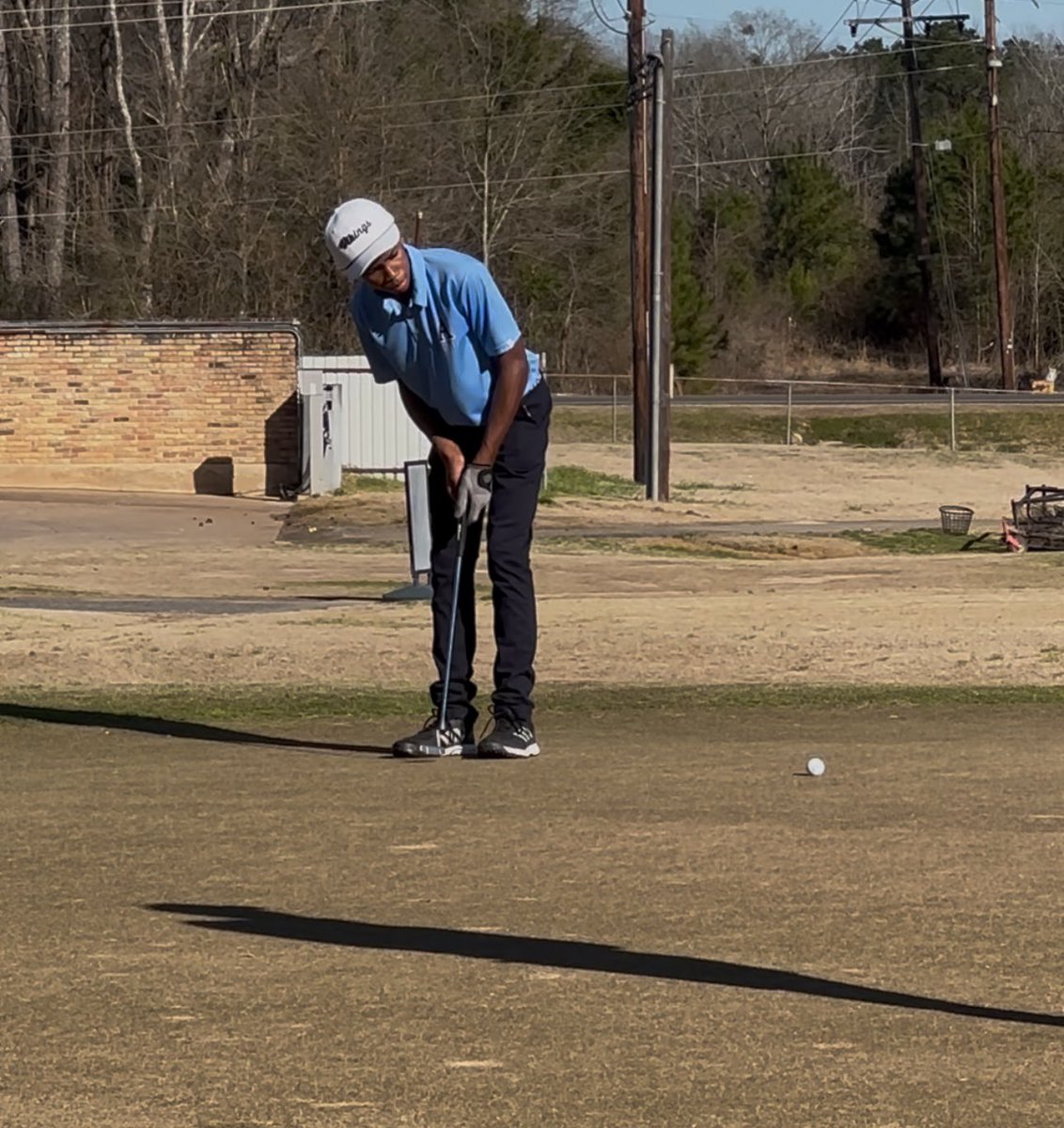Gerriel Cole putting for par.