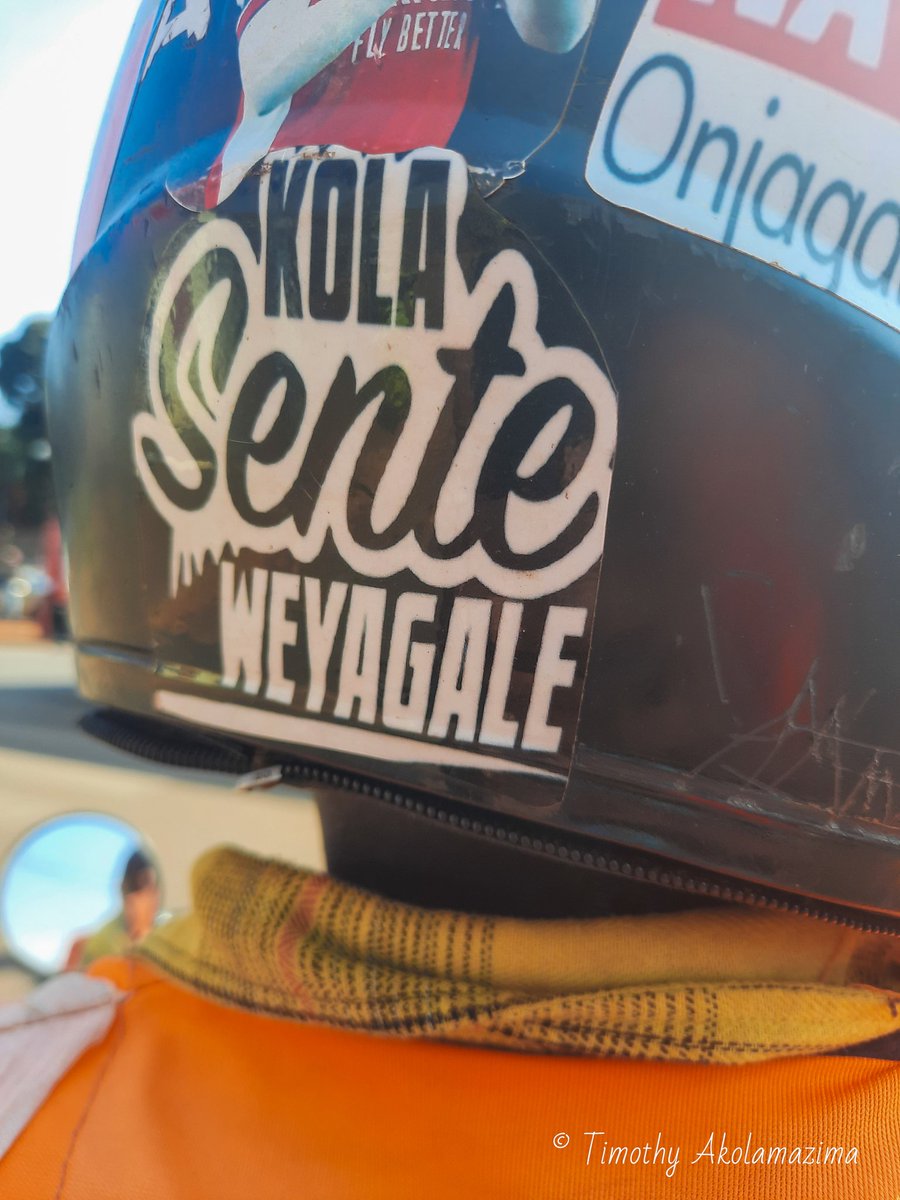 Rushing through Kampala on a boda to Mengo Senior School for a tennis class, I couldn’t help but notice my rider’s helmet message: "Kola Sente Weyagale" — Make money and enjoy life. I couldn’t agree more!

#Kampala #boda #motivationalquote