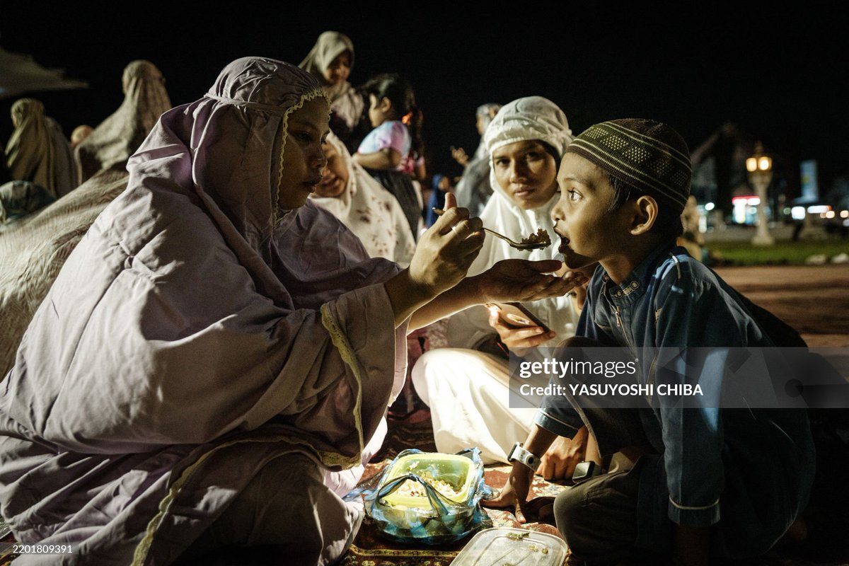 An aerial view shows Muslims offering their first Tarawih prayers to mark the start of the Islamic holy fasting month of Ramadan, at Baiturrahman Grand Mosque in Banda Aceh on February 28, 2025. 
Photo by YASUYOSHI CHIBA / AFP