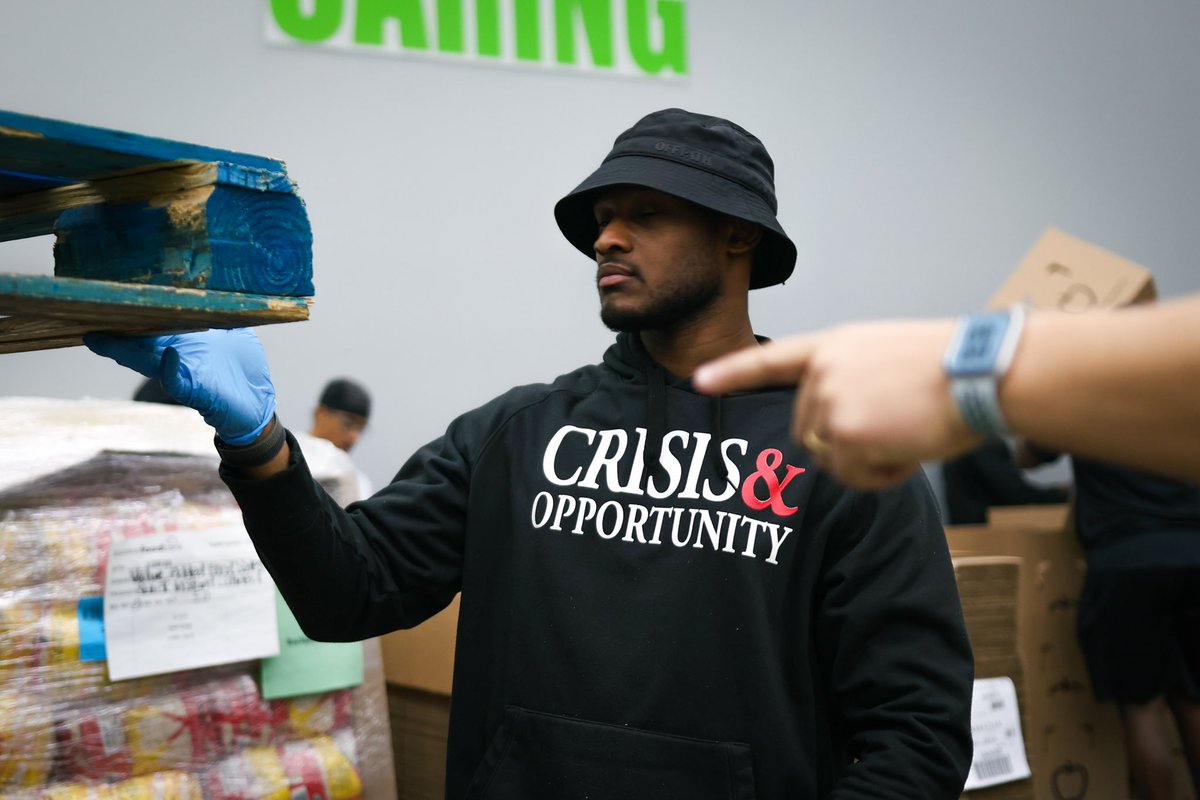 HCUFootball's tweet photo. The Huskies are Live in action at the Houston Food Bank giving back to the community. 🔵🟠⚪️ 

#DawgsUp | #TheStandard https://t.co/8APpZwtwWQ