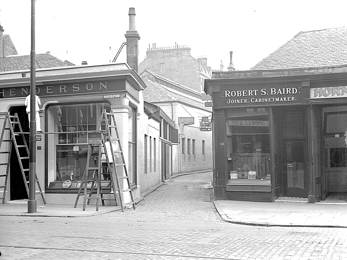Decorators working on a shop front at the entrance to Ashton Lane off Byres Road in 1933. Once filled with workshops and stables, the lane now is well known for its bars, shops and restaurants.
Ref: D-CA8/217