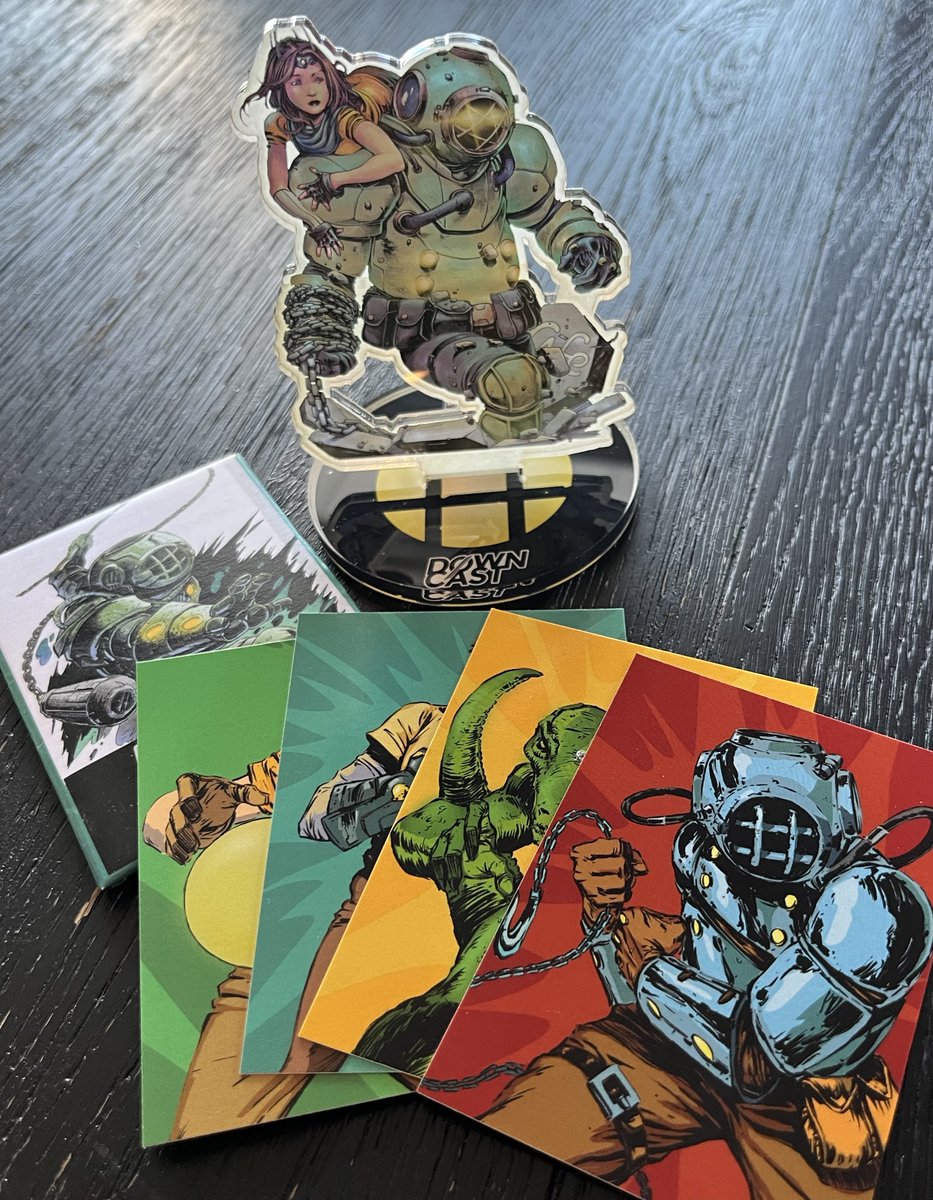 Got some new Downcast merch today! Very cool acrylic standee, and a wax pack of trading cards! (Card artwork by yours truly). These were fun to work on;  glad I could do my take on a few of these really cool characters!  Thanks again! <a href="/CastSweet/">Clint Stoker🍬</a>