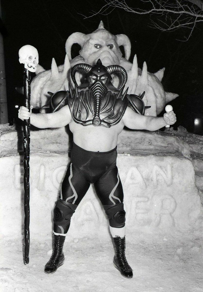 Big Van Vader poses with his own snow sculpture behind him