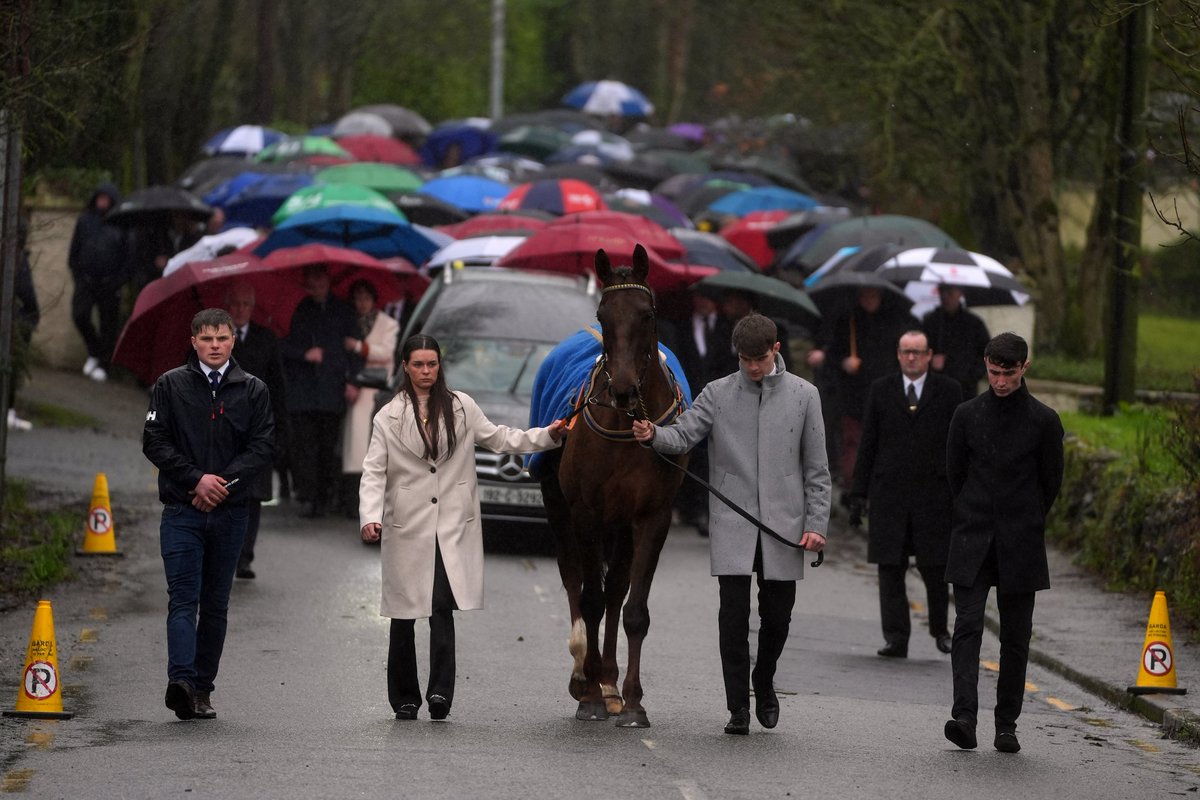 An amazing photo from Michael O'Sullivan's funeral, as a horse leads his coffin and hundreds of mourners through the rain.