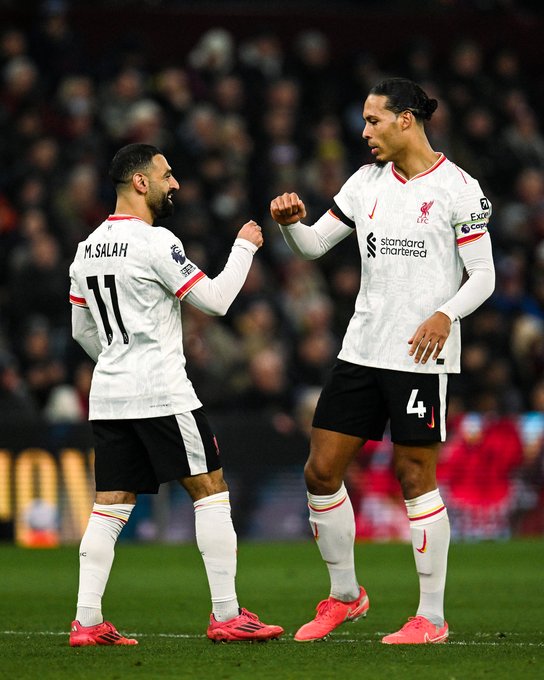 Salah and van Dijk celebrate together.