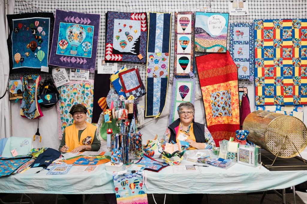 “I heard we are tied for the longest consecutive vendor at (Albuquerque International Balloon) Fiesta […] People walk into our booth and say ‘I’m back! I buy tickets every year, and I’m hoping this is the year when I win the quilt.’”Kris Lange speaking about the NMQA booth.