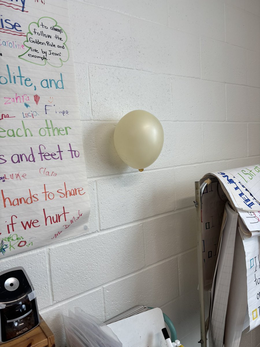Static electricity!  We got the balloon to stay on the wall for over 5 minutes !!