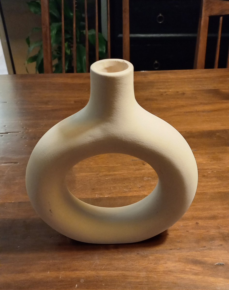 After one hour of fierce discussion, we have a solid, educated guess but are still not 100% sure: 

How many holes does this vase have?