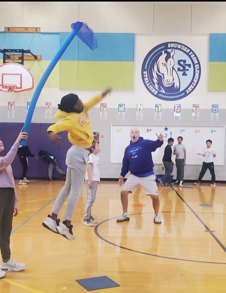 Grade 4 students practiced jumping for height at one of our learning centers.  The students self select their level of challenge and try to snag a scarf from a pool noodle at the apex of their jump. I’m in the background cheering them on!!