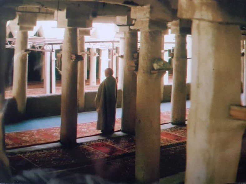NajdiMemoirs's tweet photo. A photograph of a man in prayer within Unayzah's old central mosque, taken before its demolition left only the minaret standing. https://t.co/7sJDHL2gfF