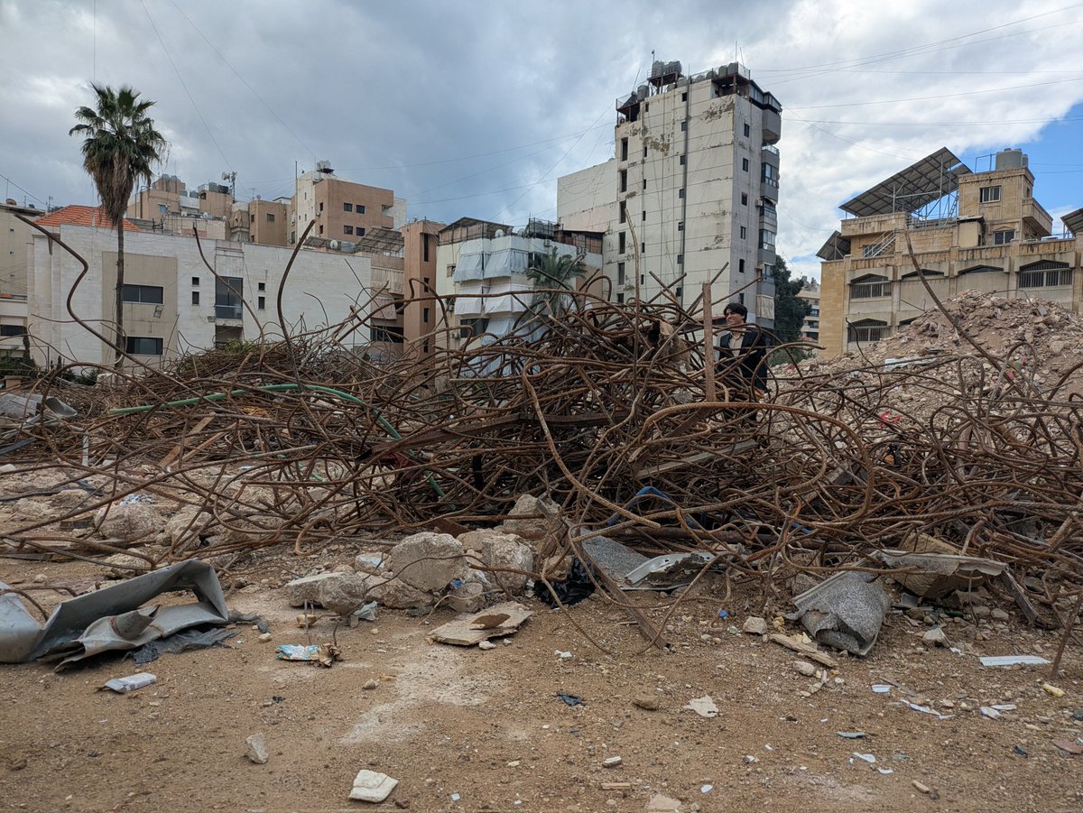 TaraAOGrady's tweet photo. meanwhile his wife handed me coffee from their flask. On the ground there are broken pieces of lifes accoutrement; childrens school books, shoes, scraps of clothing, broken toys and kitchen utensils. 
#Beirut
#Nasrallah
#Lebanon #Libnan https://t.co/rLcba2eqb4