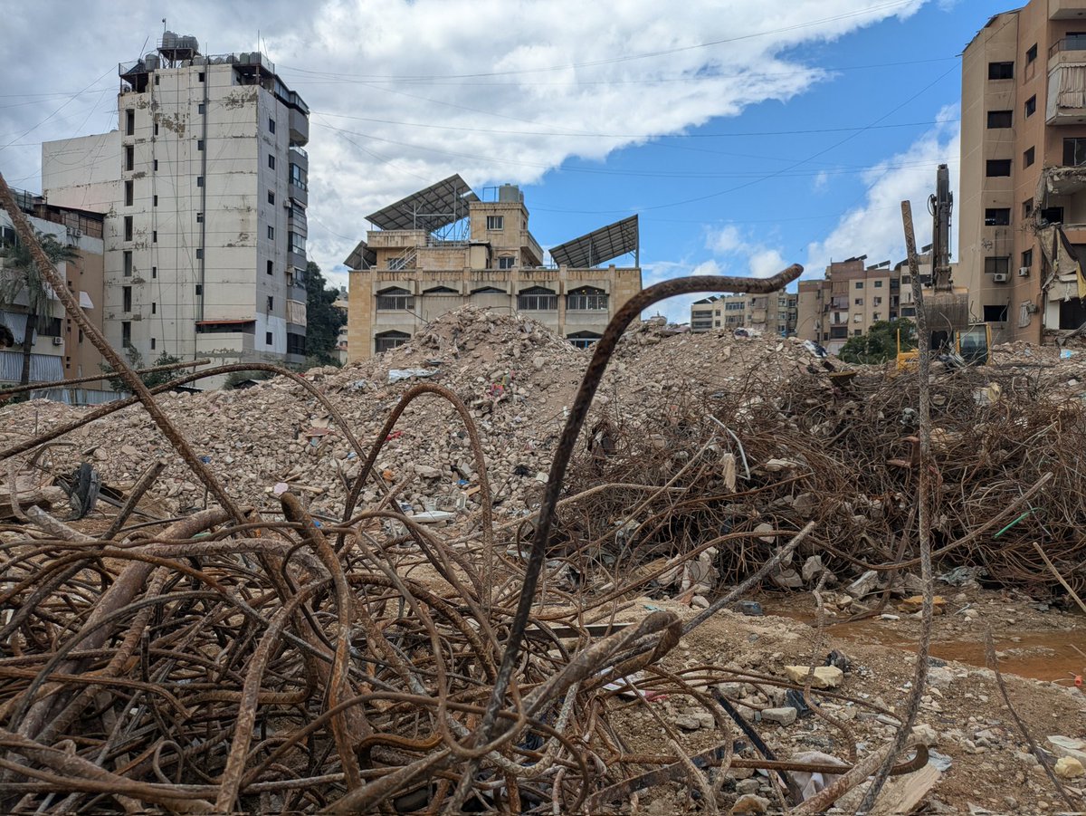 TaraAOGrady's tweet photo. meanwhile his wife handed me coffee from their flask. On the ground there are broken pieces of lifes accoutrement; childrens school books, shoes, scraps of clothing, broken toys and kitchen utensils. 
#Beirut
#Nasrallah
#Lebanon #Libnan https://t.co/rLcba2eqb4