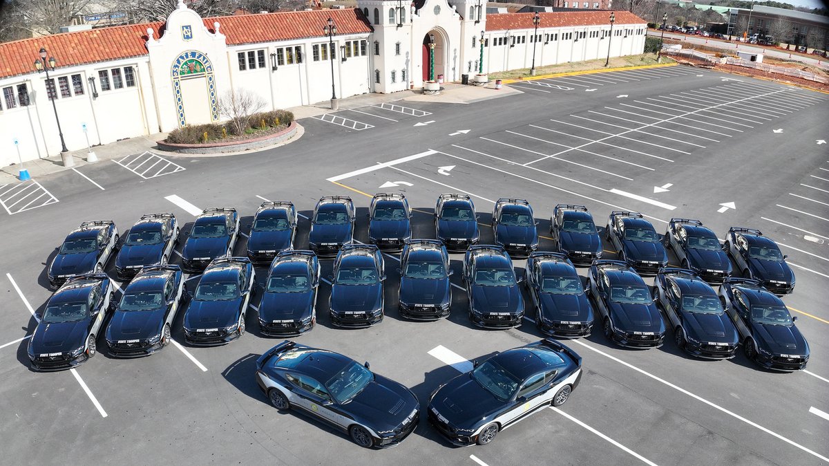 NCSHP's tweet photo. This month @NCSHP commemorated our official release of new Ford Mustang cruisers for statewide patrol coverage. Governor Josh Stein joined Colonel Freddy Johnson Jr. at the State Fairgrounds in Raleigh to recreate an iconic image from 1929 showcasing the original @NCSHP members. https://t.co/bJecBTvpQT