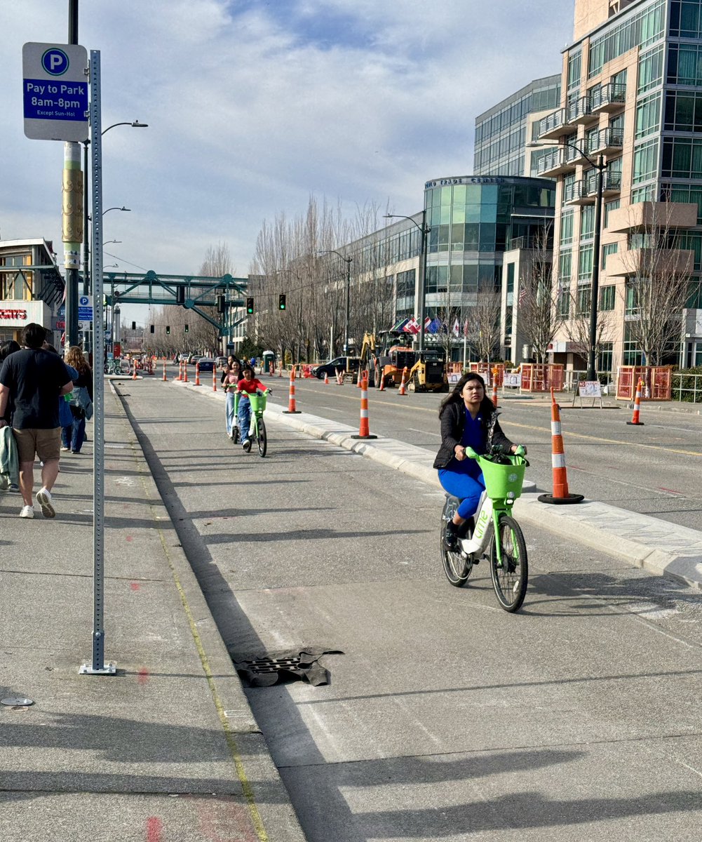 Happy people enjoying the not-yet-open Alaska Way protected bike lane on a beautiful Saturday afternoon