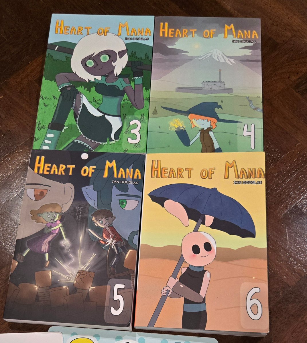 Got some amazing books in the mail today! Volumes 3-6 of the webcomic Heart of Mana by <a href="/Chaos_Composer/">ChaosComposer</a> !!! 🤩

The books are so well made and excellent quality!! I can't wait to read through them all! 

Go check the series out for yourself here!! 😁:

heartofmana.carrd.co